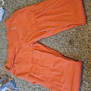 A pair of work plants from flamingo size 3XL and are a corl color